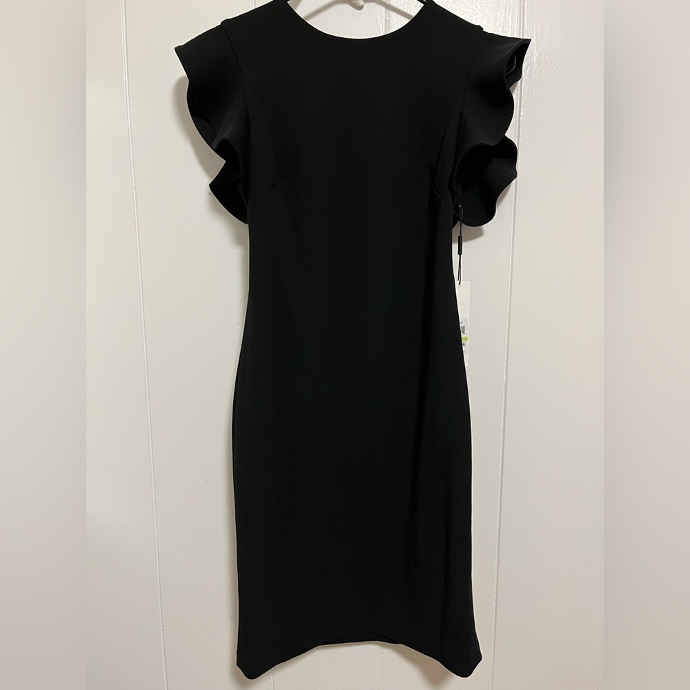 Never worn CALVIN KLEIN beautiful lined flutter sleeve little black dress.